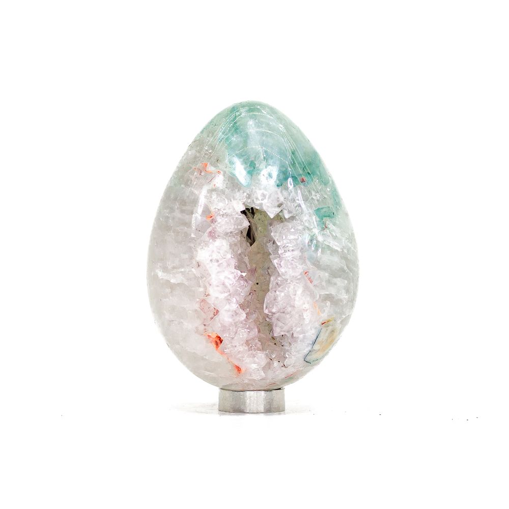 Cream-coloured calcite crystal points crowning a base of purple amethyst.